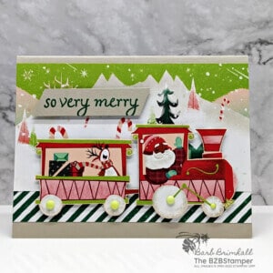 WHimsical Handmade Christmas card featuring paper that has a train and Santa and reindeer