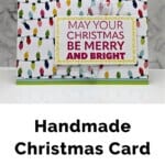 Christmas card featuring the Joy To You Stamp Set by Stampin' Up! Uses pretty paper featuring light bulbs in a variety of colors and a bold Christmas sentiment.
