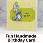 Handmade Birthday Card with the Stampin Up! Zany Zoo Bundle with a racoon holding balloons and a musical note embossed on yellow cardstock.