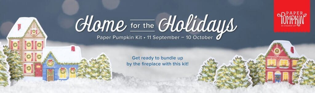 October 2023 Monthly Crafting Subscription Box featuring a Christmas Theme with homes, trees, sitting on snow.
