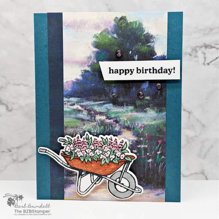 Handmade Birthday Card featuring the Garden Meadows Bundle in blues and greens with a wheelbarrow with flowers.