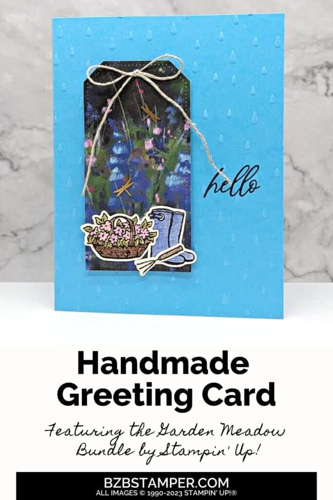 Magical Meadows Bundle from Stampin' Up! in different shades of blues and purples. Features a tag on the front of the card, with hello greeting and flowers, a gardening tool and rainboots.