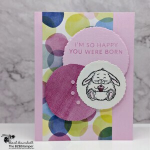 Bunny Bliss with the Fluffiest Friends Bundle by Stampin' Up! Features fun paper in circles in pinks, purples and green with a cute bunny holding a cupcake images and a sentiment of I'm so happy you were born.
