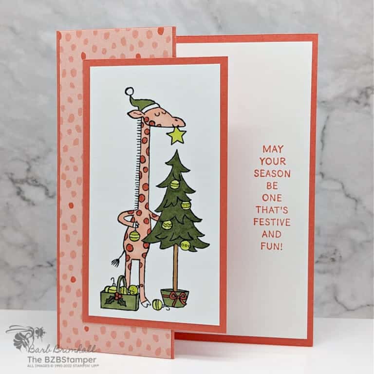 Orange and green Christmas card featuring a giraffee with the sentiment "May your season be one that's festive and fun."