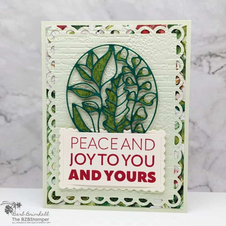 Christmas card in green and red with many die-cut images and a sentiment "Peace and Joy to You and Yours."