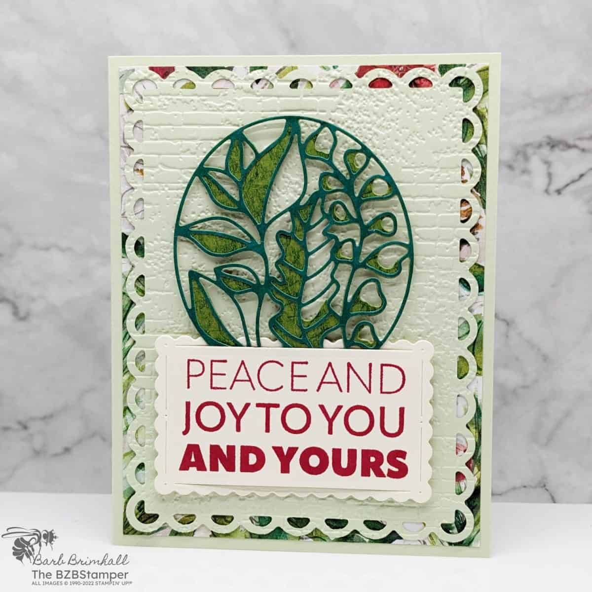 Elegant Joy To You Christmas card in green and red with many die-cut images and a sentiment "Peace and Joy to You and Yours."