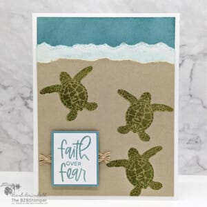 Handmade card in blue, green and crumb cake featuring 3 turtles and a "faith over fear" sentiment.