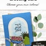 Handmade card in blues, greens and pinks featuring a wheelbarrow with flowers underneath an arch with sentiment "every day is a fresh start."