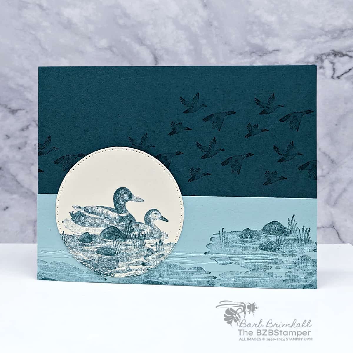 Monocromatic Feathered Flight Stamp Set in blues featuring ducks floating on the water.