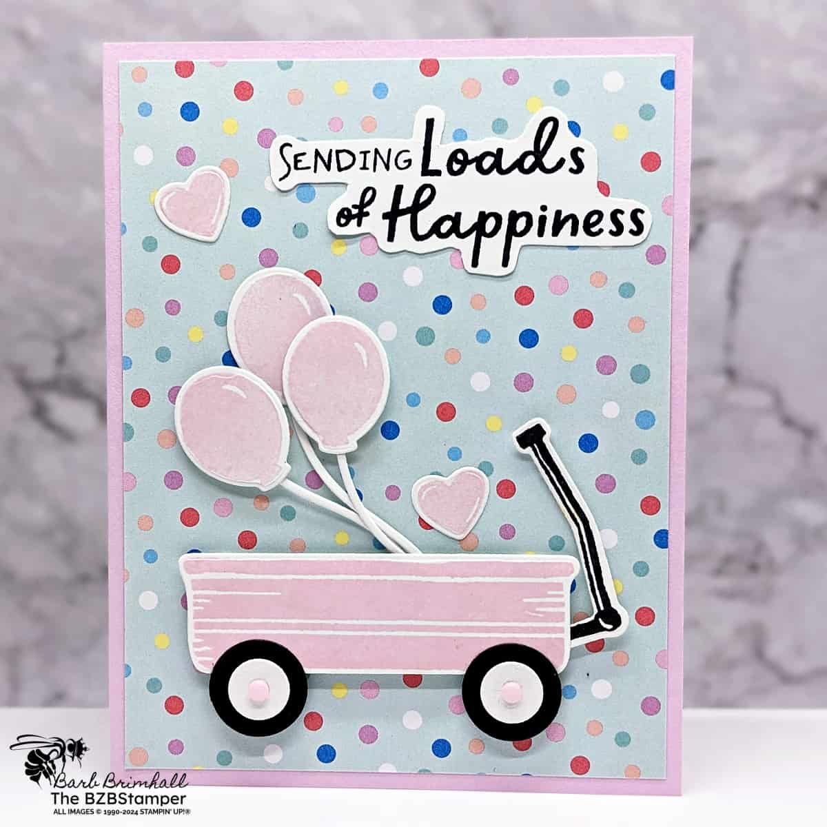 Filled With Fun Happiness Wagon with a polka dot background and a wagon with balloons in Barbie pink.  Sentiment is "sending loads of happiness."