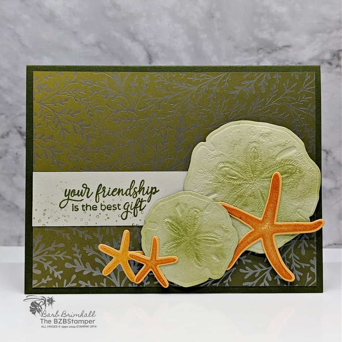 Handmade Seaside Wishes Friendship Card featuring seashells and starfish with pretty paper background.  Sentimet is "your friendship is the best gift."