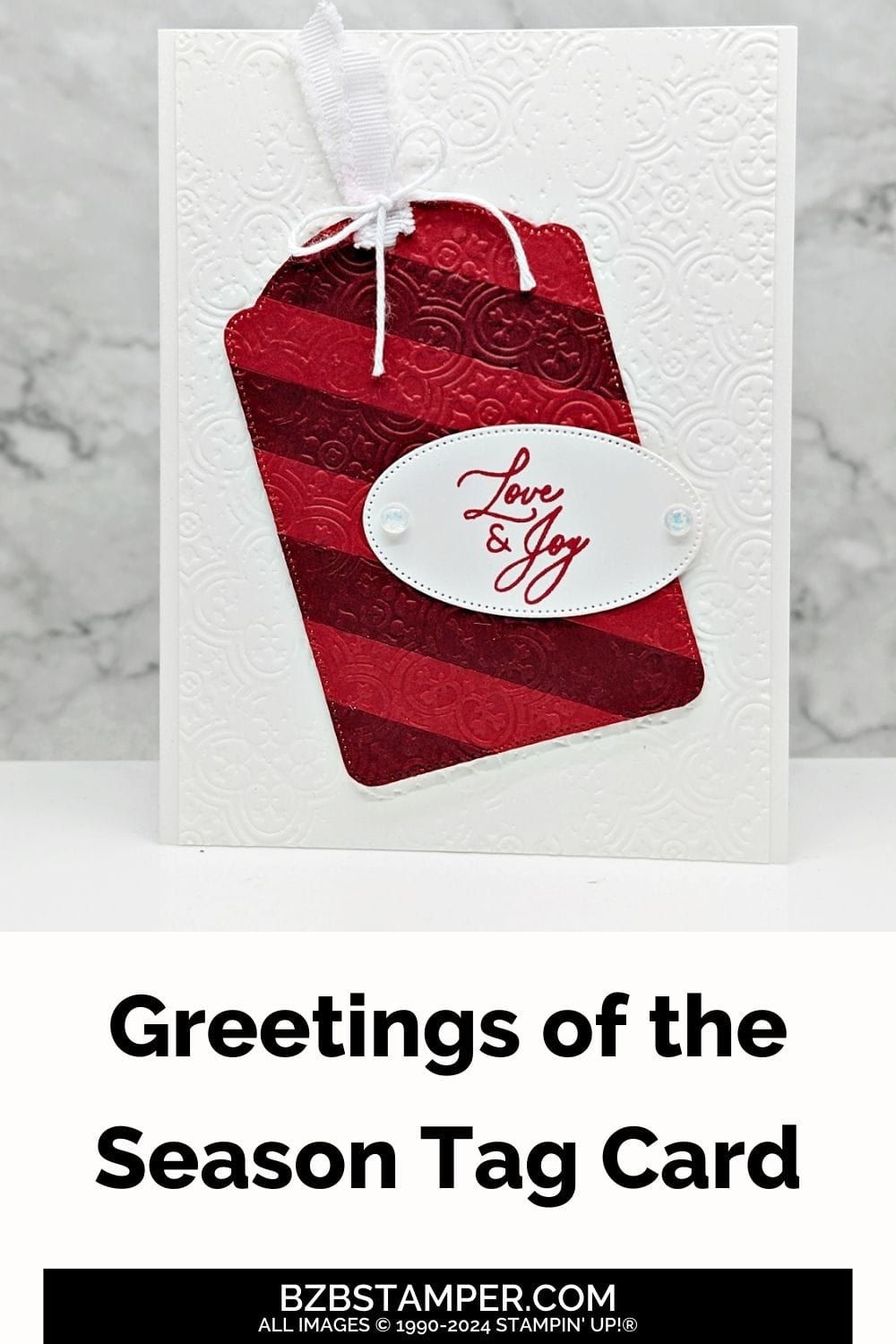 Greetings of the Season Tag Card in white and reds, with an embossed background and oval tag with "love & joy" sentiment.