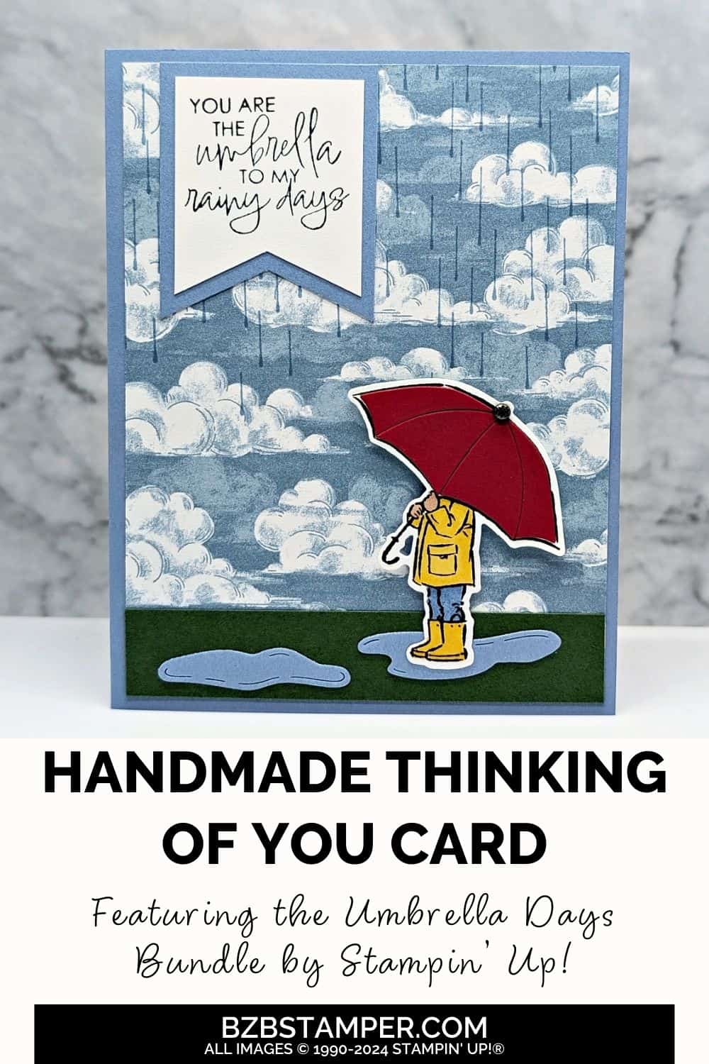 You Are the Umbrella to My Rainy Days handmade card featuring rainclouds and raindrops in blues and a person holding a red umbrella with the sentiment "you are the umbrella to my rainy days."