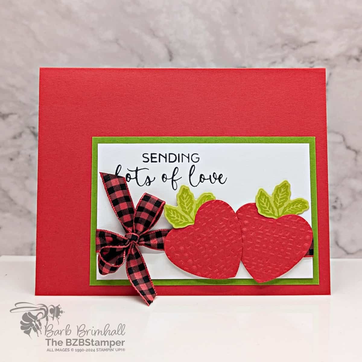 Strawberry Love Card with Hearts of Elegance Bundle featuring 2 red strawberries with green leaves and a red check ribbon with the sentiment "sending lots of love."