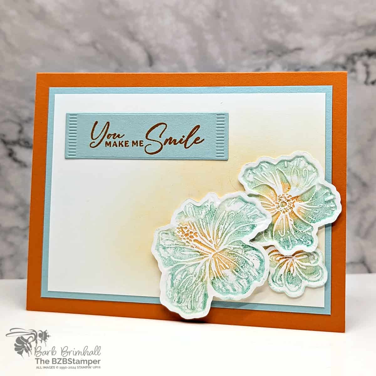 Happy Hibiscus All-Occasion Card in blues and oranges featuring 3 die-cut hibiscus flowers and a sentiment "you make me smile"
