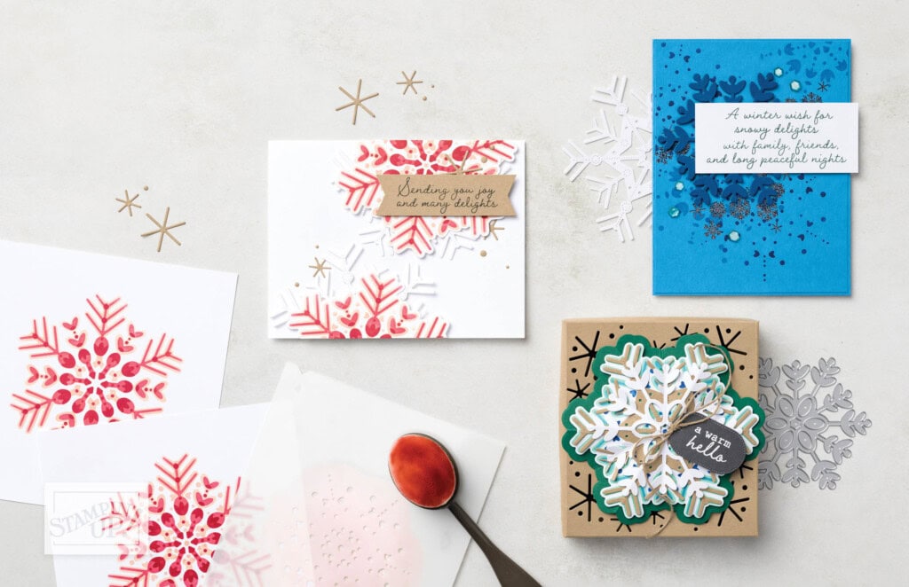 Winter-themed handmade cards and a decorated gift box created using Stampin’ Up! Blending Brushes with ink and stencils for bold snowflake designs.