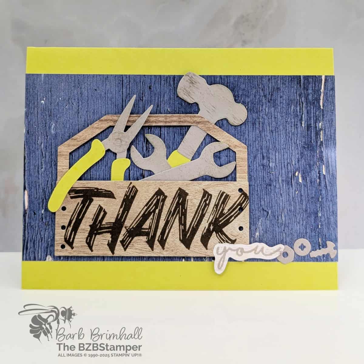 Masculine Thank You Card Using Layered Thoughts Stamp Set with a "thank you" sentiment featuring a box of tools, some pretty woodgrain paper and a bright green card base.