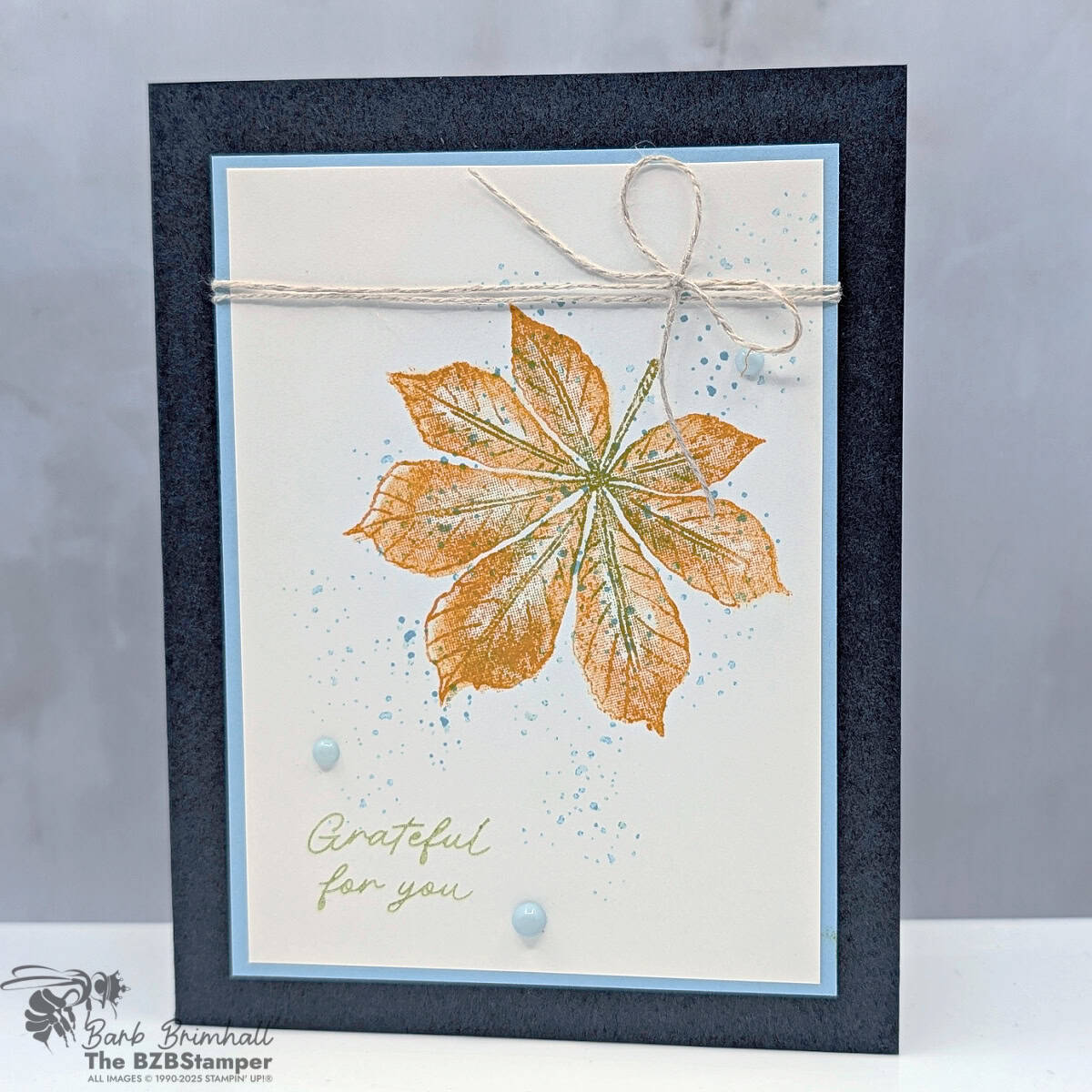 Simple Thank You Card with Artistic Leaves featuring a large stamped leaf in Pumpkin Pie and Old Olive, accented with Balmy Blue splatters, linen thread, and enamel dots.