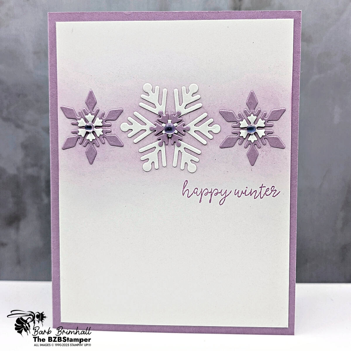 Handmade Happy Winter card with Snowflake Kisses Bundle featuring layered die-cut snowflakes, Fresh Freesia ink background, and frosted iridescent dots.