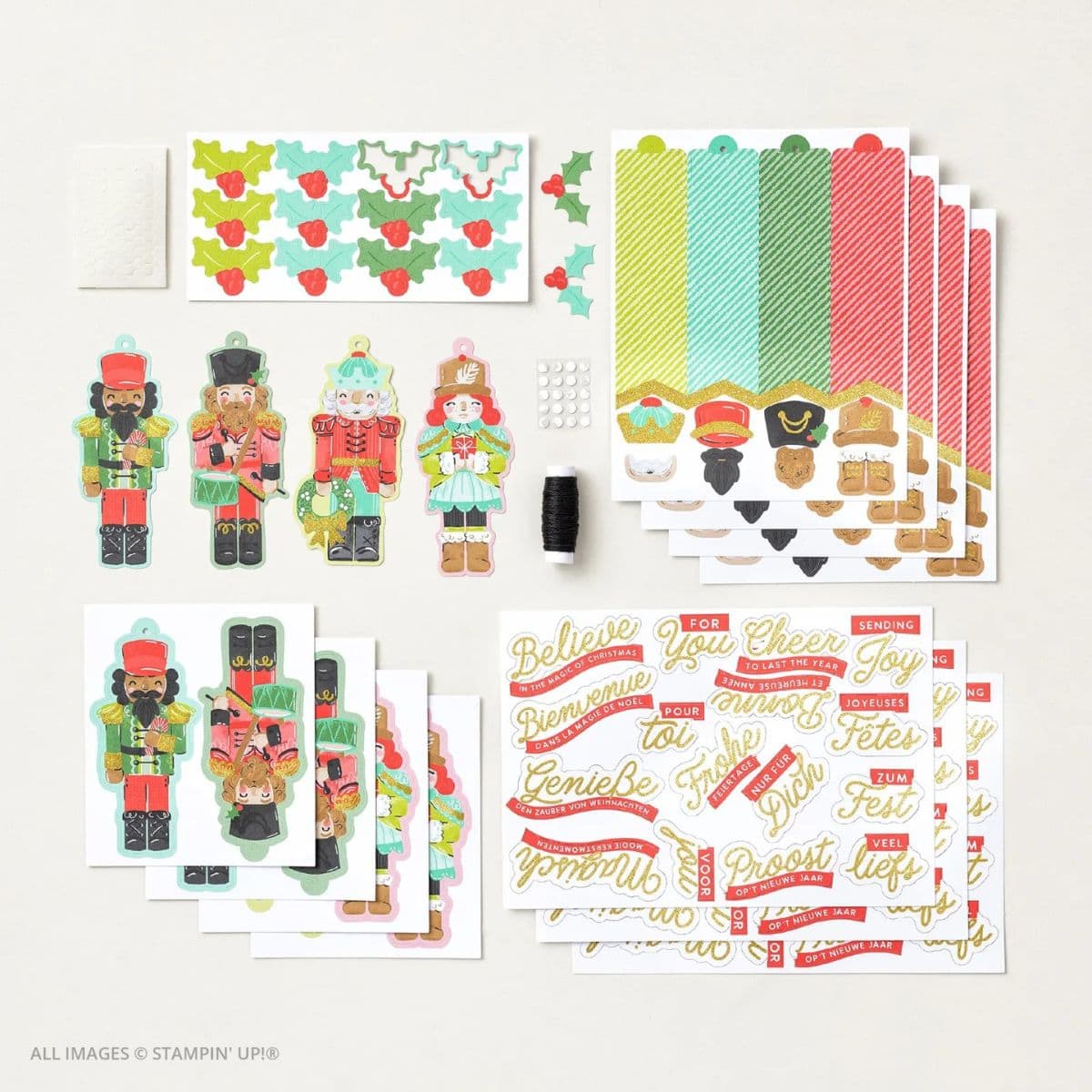 Easy Christmas Tags with the Nutcracker Tags Kit , including colorful nutcracker die-cuts, striped tag bases, gold-foiled sentiment sheets in multiple languages, holly leaf embellishments, baker’s twine, adhesive dots, and assembly instructions—all arranged neatly on a white background.
