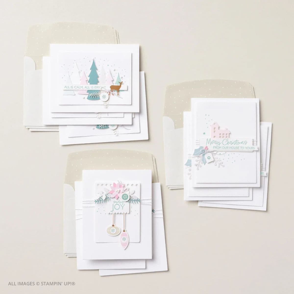 Calm & Bright Kit for Simple Handmade Christmas Cards picture of flat lay of completed handmade Christmas cards from the Calm & Bright Kit, featuring soft pastel designs, layered die-cuts, and coordinating envelopes with subtle shimmer.