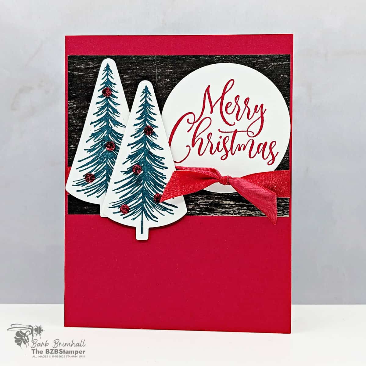 Handmade Merry Christmas Card Idea featuring Real Red cardstock, Pretty Peacock trees, Early Espresso patterned paper, and a red ribbon accent with a "Merry Christmas" sentiment on a circle.