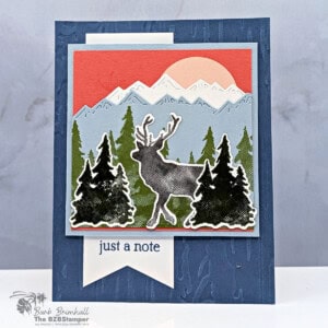 Colorful layered holiday card featuring a reindeer silhouette, mountain, forest, and sunrise scene, created by Barb Brimhall, The BZBStamper.