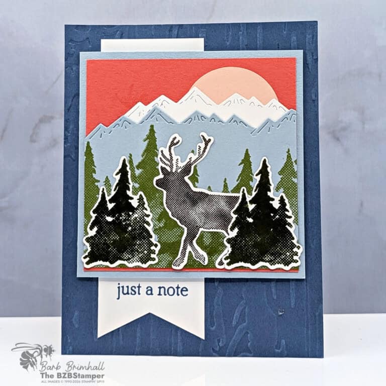 Colorful layered holiday card featuring a reindeer silhouette, mountain, forest, and sunrise scene, created by Barb Brimhall, The BZBStamper.