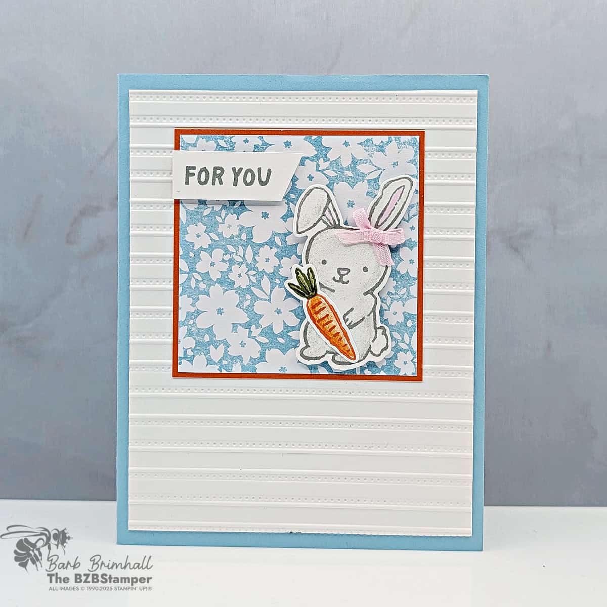 Cute bunny Easter card with carrot, pink bow, "For You" sentiment, floral background, handmade stamping design.
