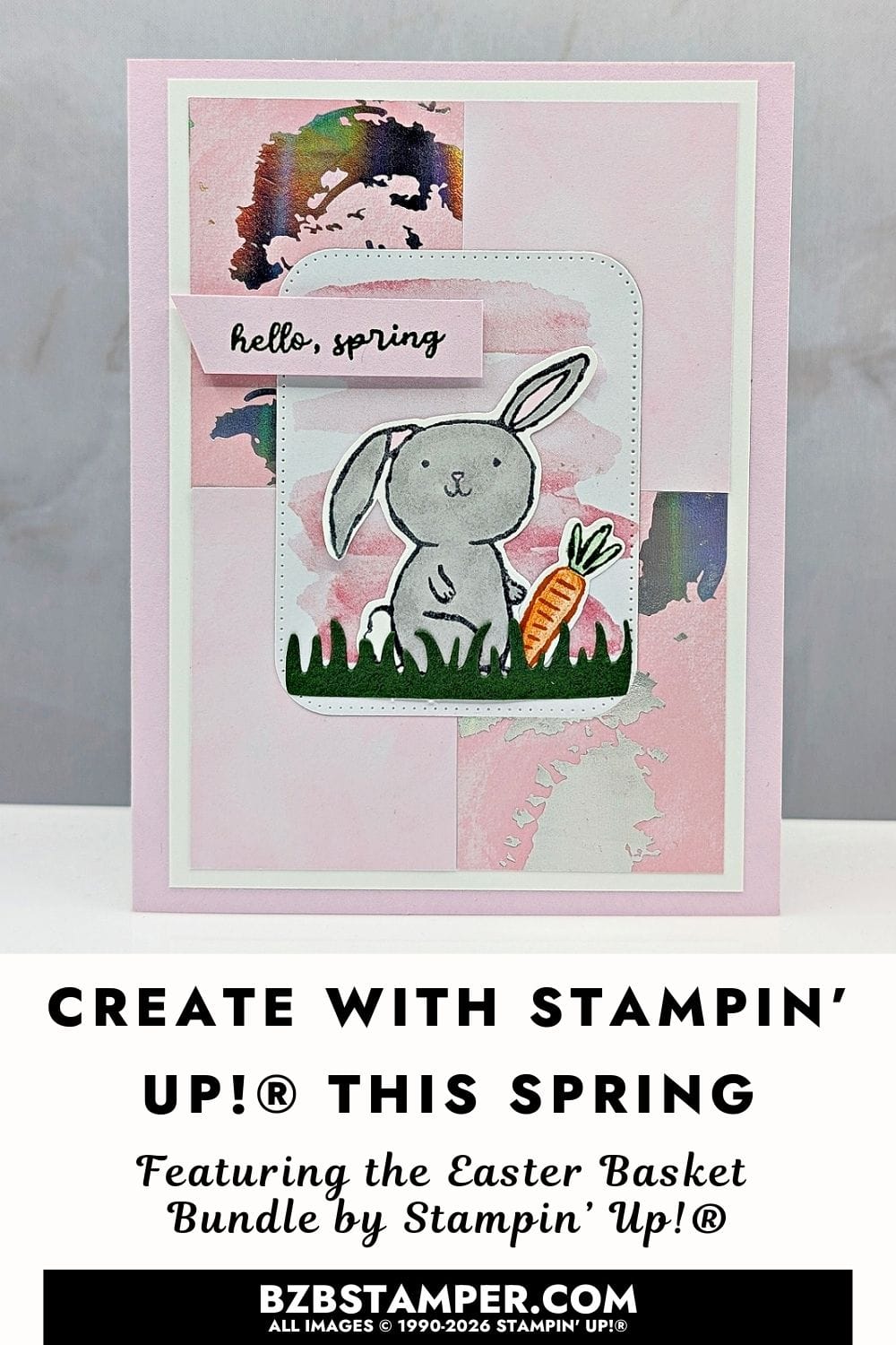 Spring Card Using The Easter Basket Bundle features a soft pink background, layered white and pastel panels, and a small bunny sitting in a woven basket with flowers and grass. The basket is brown with a blue bow, the bunny is softly shaded, and the overall design feels light, fresh, and cheerful.